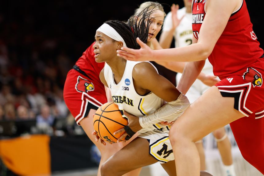 Michigan Wolverines guard Brooke Q. Daniels (5) drives to the basket ahead of Louisville Cardinals forward Elif Istanbulluoglu (11) during the second half at Dickies Arena in Texas on March 28, 2026.