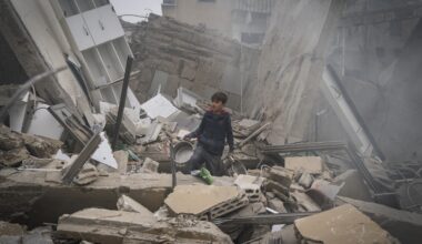 A child searches for kitchen tools inside of the debris of a building that has collapsed after an IDF airstrike on March 18, 2026 in Beirut, Lebanon.