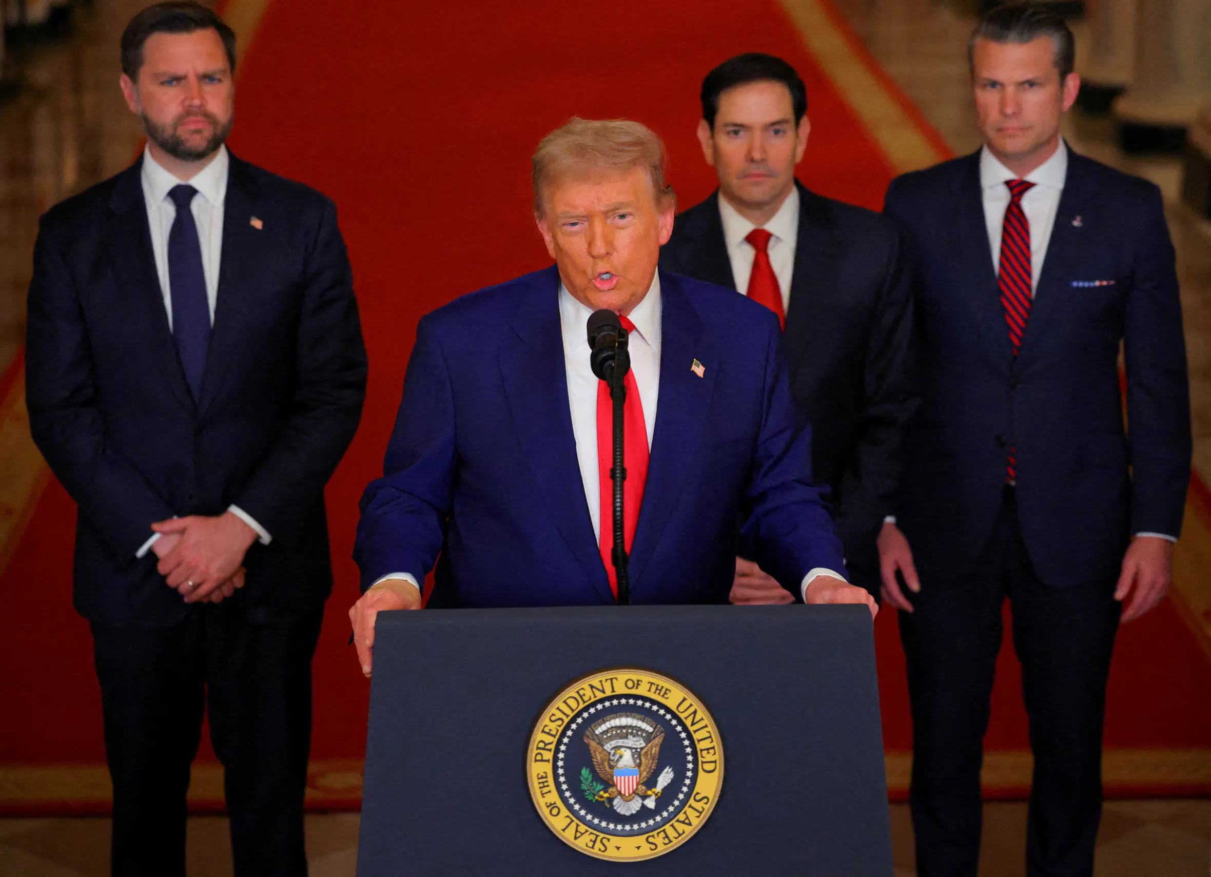 U.S. President Donald Trump delivers an address to the nation from the White House, accompanied by Vice President JD Vance, Secretary of State Marco Rubio, and Secretary of Defense Pete Hegseth.