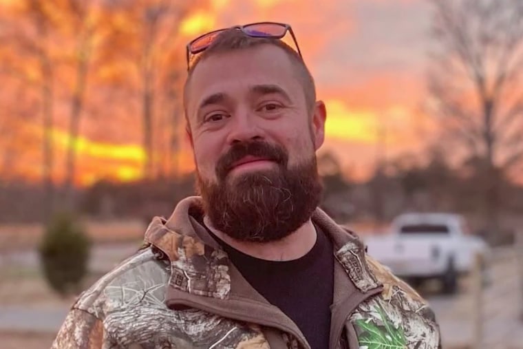 Aaron Spencer stands outside during sunset