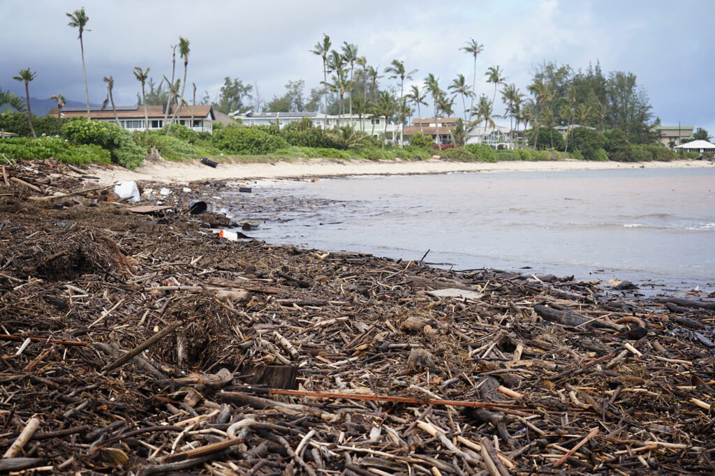 Debris on Pu‘uiko Beach and in the water is photographed Monday, March 23, 2026, in Waialua. A second Kona low storm brought heavy rain after the previous week’s downpour and high winds. (Kevin Fujii/Civil Beat/2026)