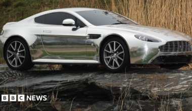 An Aston Martin motor car is displayed outside the company headquarters and production plant in Gaydon