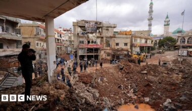 People inspect the damage where Israel's military carried out an airborne operation that dropped troops overnight, in the town of Nabi Chit.