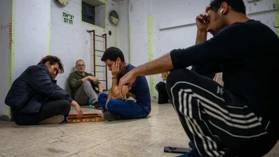 People play the game "sheshbesh" in an underground bomb shelter after sirens warned of an incoming Iranian missile in Tel Aviv, Israel, on March 16, 2026. - Alexi J. Rosenfeld/Getty Images