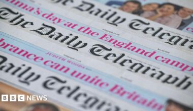 Three daily telegraph copies laying on top of each other in a pile where the headline is visible