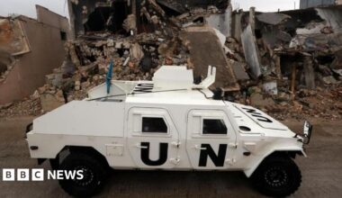 An armoured vehicle of the United Nations Interim Force in Lebanon (UNIFIL) drives next to destroyed buildings in Meiss al-Jabal, Marjayoun district, southern Lebanon, 08 December 2025.