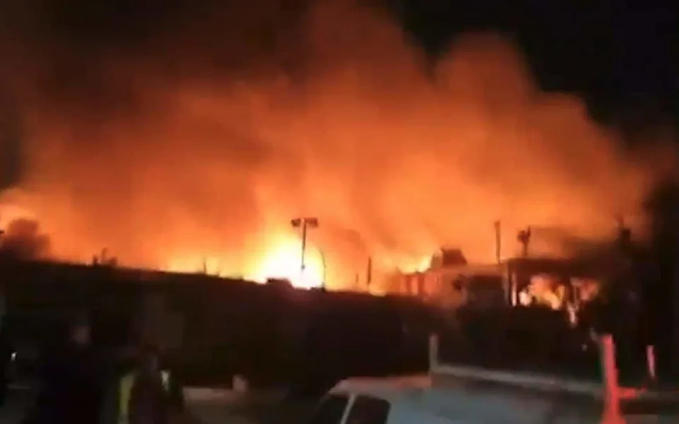 Flames rise over the Tel Aviv skyline during the Iranian missile barrage