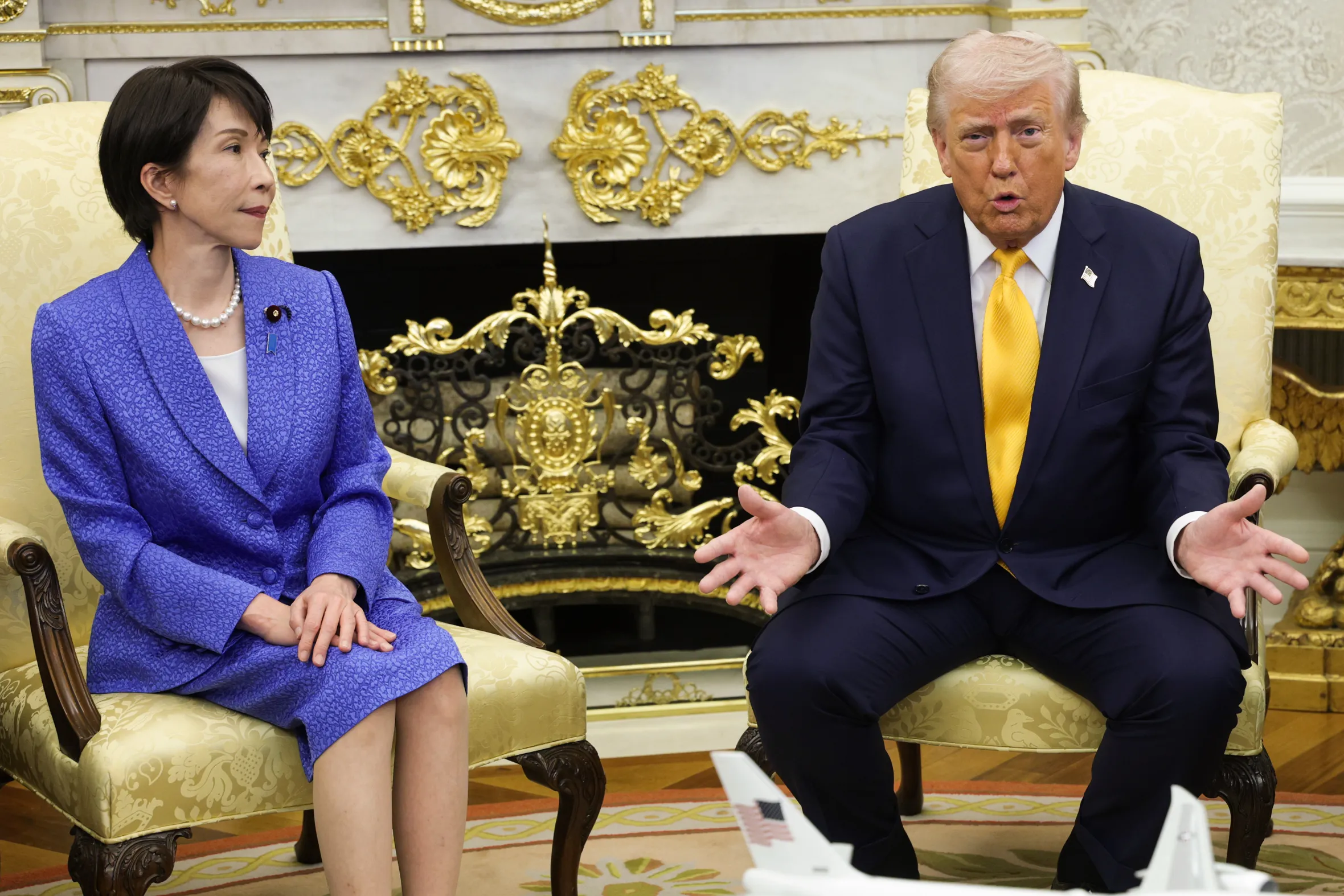 President Trump and Japanese Prime Minister Sanae Takaichi sit in chairs in the Oval Office.