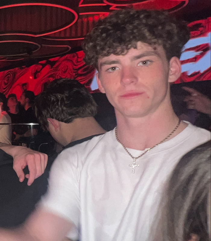 Young Alabama student in a white shirt and cross necklace captured in dimly lit club, linked to harrowing final moments testimony. Young Alabama student in a white shirt and cross necklace captured in dimly lit club, linked to harrowing final moments testimony.