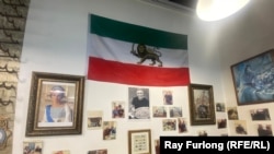 Bijan Bahordari is proud of this wall in his cafe, with photos of famous guests and the late Iranian royal couple.