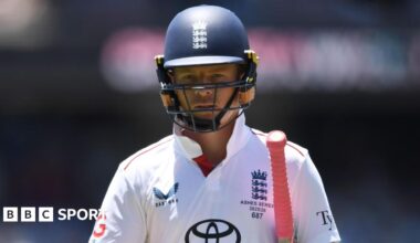 Ollie Pope looks dejected, with his bat under his arm