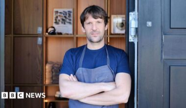 Rene Redzepi, chef and co-owner of Danish restaurant Noma is pictured on May 31, 2021 in Copenhagen wearing a blue t-shirt and apron with his arms crossed.