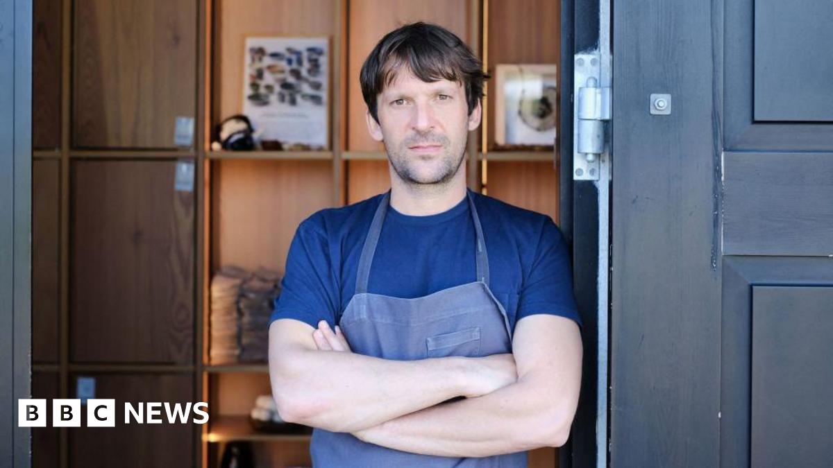 Rene Redzepi, chef and co-owner of Danish restaurant Noma is pictured on May 31, 2021 in Copenhagen wearing a blue t-shirt and apron with his arms crossed.