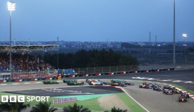 F1 cars race through first corner of Sakhir circuit in Bahrain