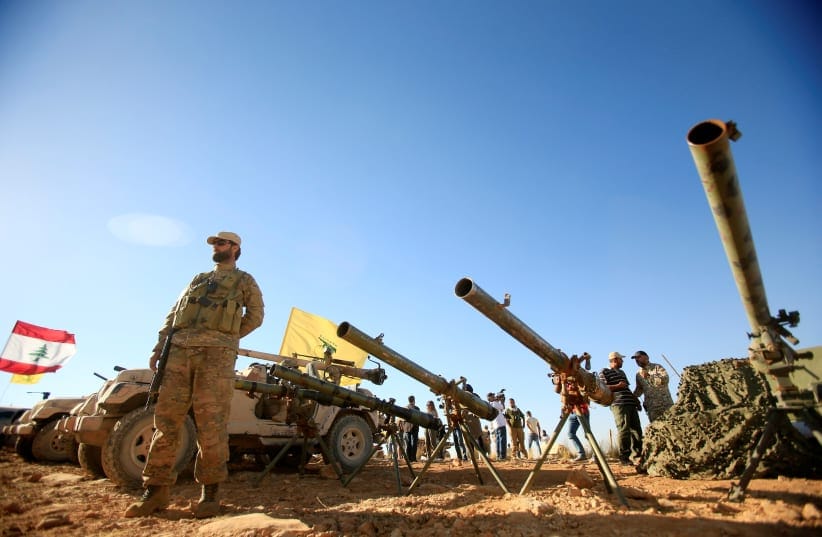A Hezbollah fighter stands in front of anti-tank artillery at Juroud Arsal, the Syria-Lebanon border.