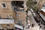People look at a destroyed apartment after a hit of a ballistic missile fired from Iran, left two injured on Wednesday in Bnei Brak, Israel.