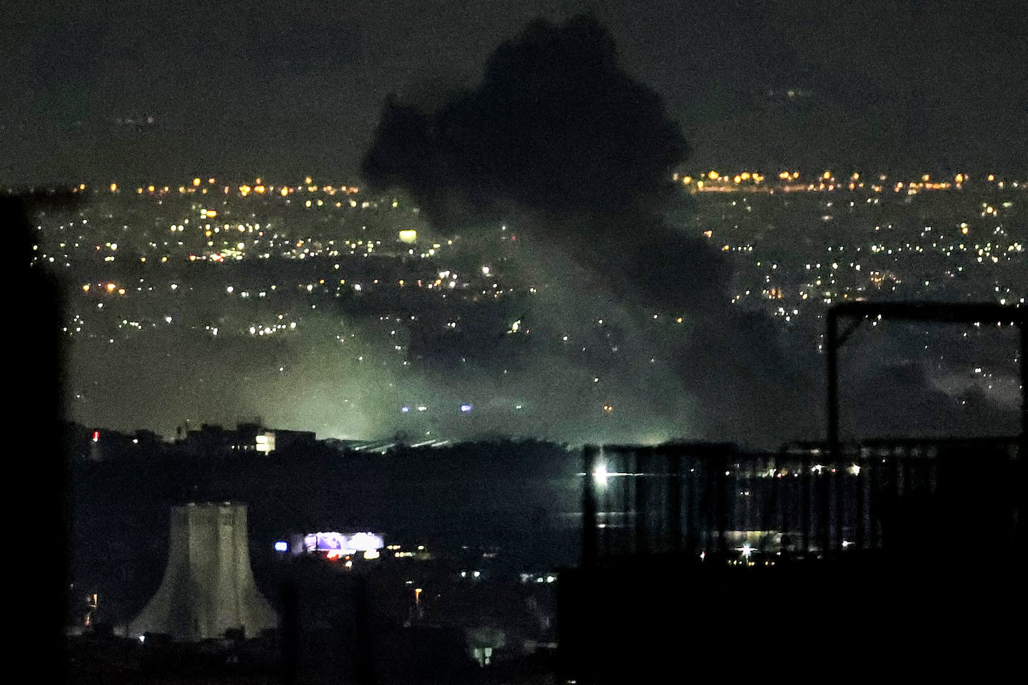 Smoke plumes billow from the site of airstrikes near Azadi Tower in western Tehran on March 10.