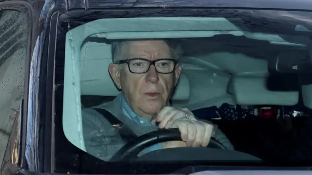 Peter Mandelson sitting behind the wheel of a car
