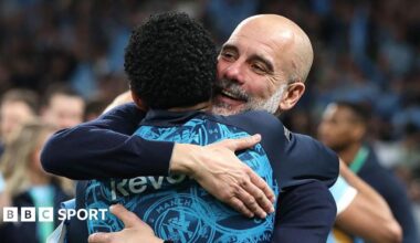 Pep Guardiola hugs his players