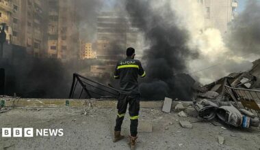A member of the civil defence stands at the site of overnight Israeli airstrikes in the southern suburbs of Beirut