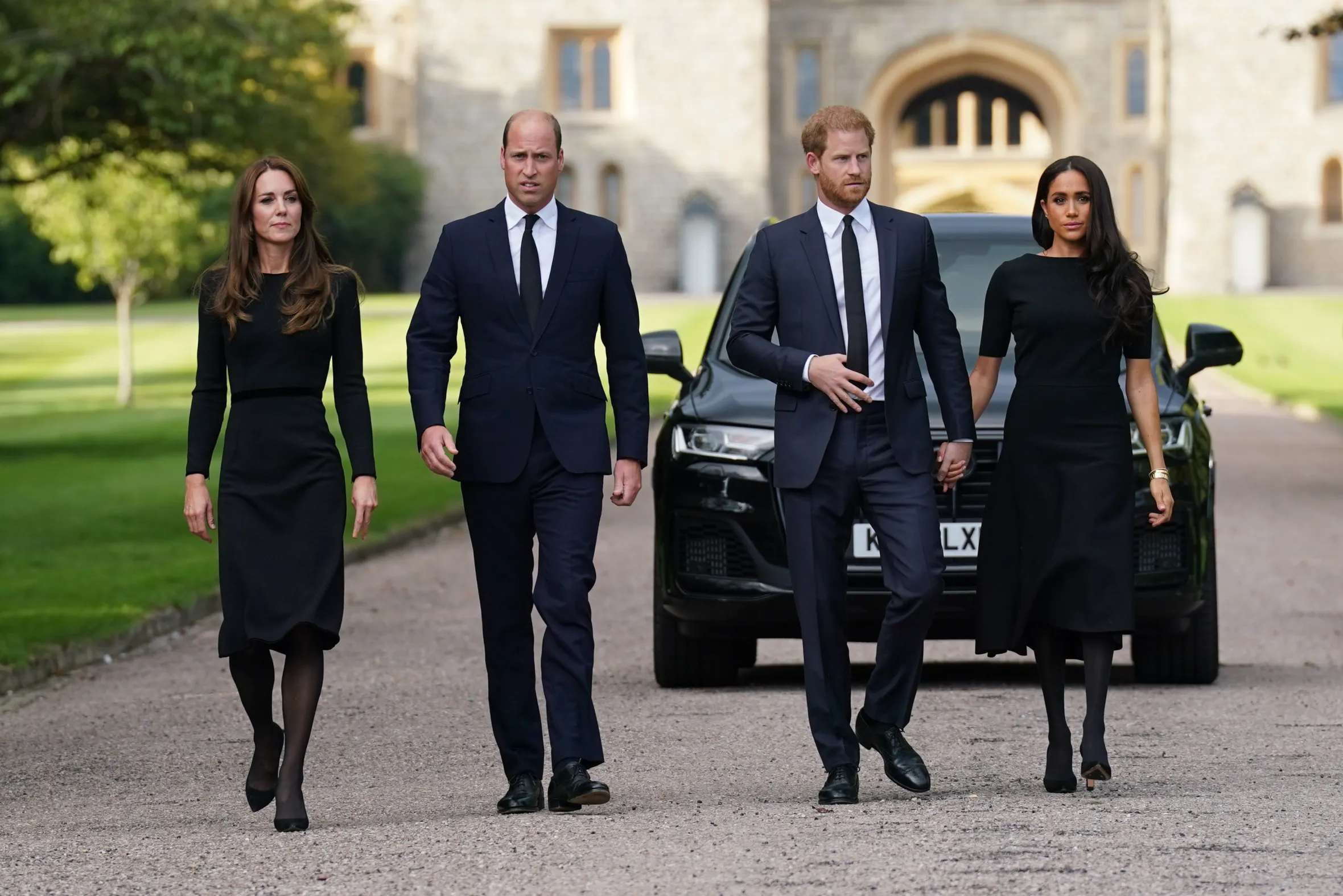 The Princess of Wales, the Prince of Wales, and the Duke and Duchess of Sussex walk to meet members of the public at Windsor Castle.