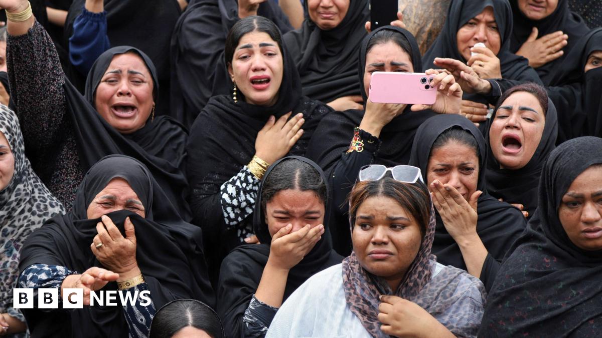 People looking for survivors in the rubble of the school in Minab
