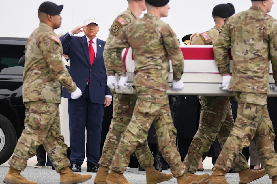Mark Schiefelbein/AP - PHOTO: An Army carry team moves a flag-draped transfer case with the remains of U.S. Army Reserve soldier Sgt. 1st Class Nicole Amor past President Donald Trump during a casualty return, March 7, 2026, at Dover Air Force Base, Del.