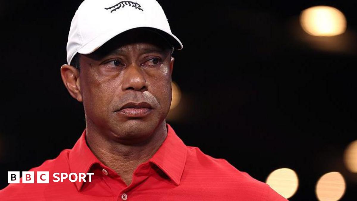 Tiger Woods in a red shirt and white cap