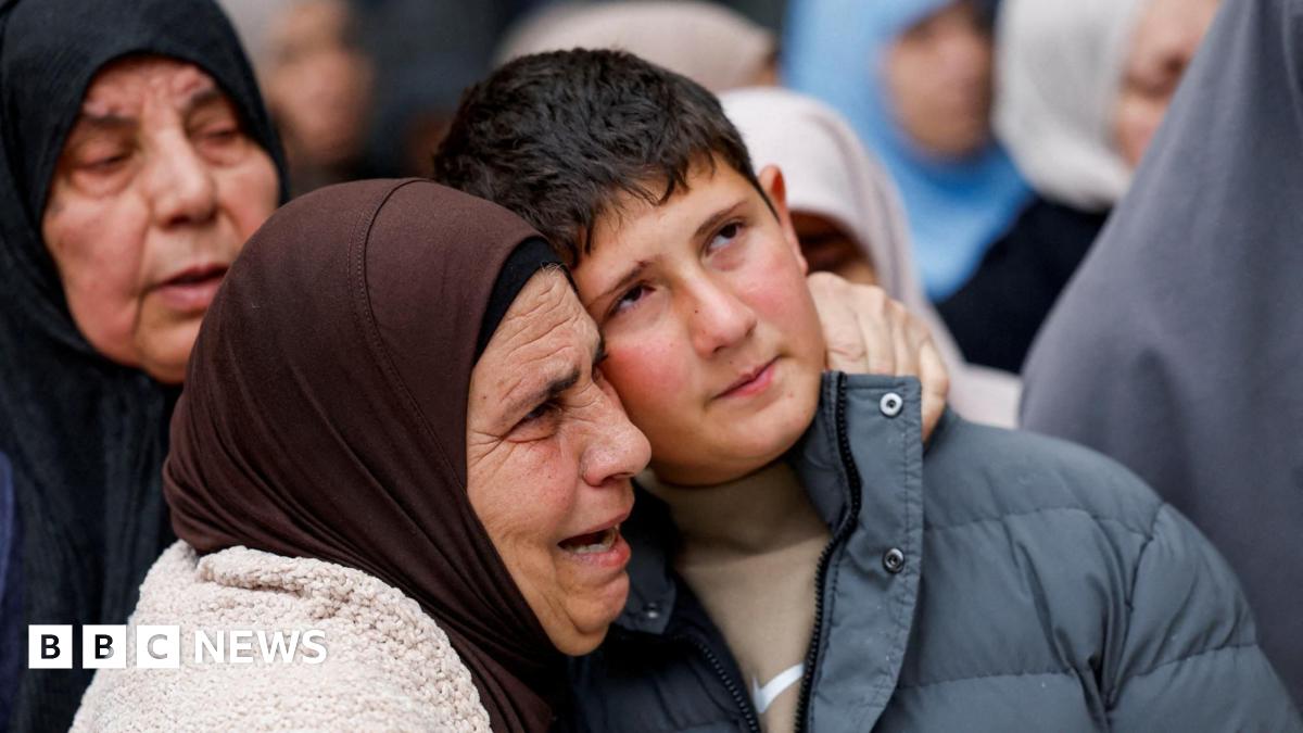 Khaled Bani Odeh is embraced by a woman during the funeral for his parents and two of his brothers in Tammun, in the Israeli-occupied West Bank (15 March 2026)