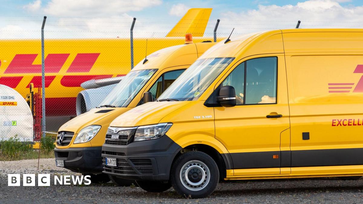 Two yellow DHL vans in front of a cargo plane parked on Leipzig Halle airport terminal