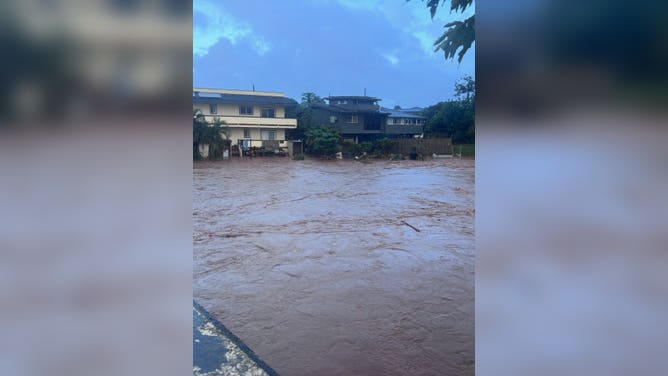 Flooding rises to the decks of some homes on O'ahu on Friday, March 20, 2026.