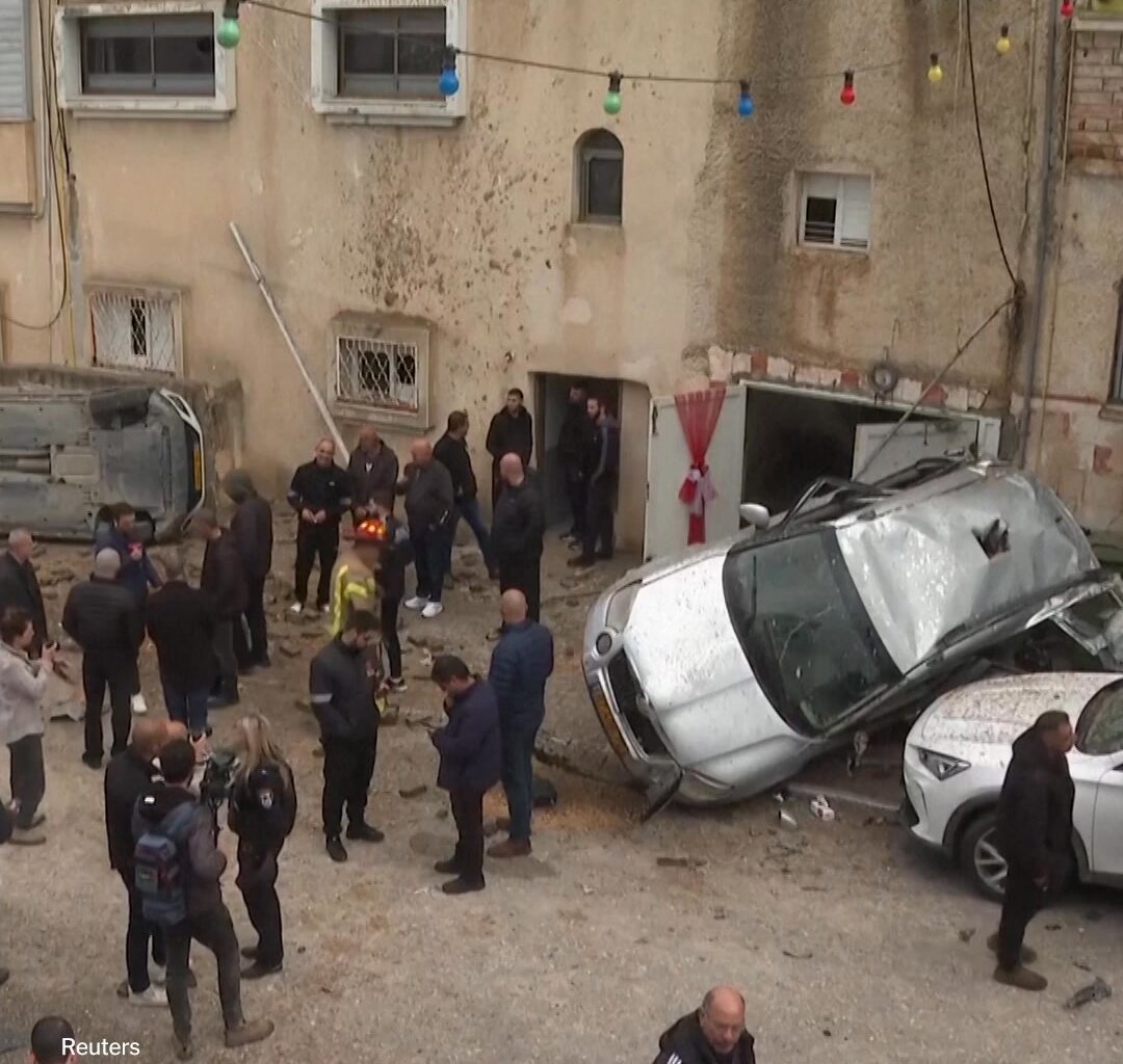 Video footage shows two people in Israel barely missing being hit by what the Israeli military said was bomblet from an Iranian cluster bomb. Emergency responders said that five others were treated from the blast. The attack came as President Trump ratcheted up pressure on Iran to agree to a peace deal to stop the war.  https://nyti.ms/40XFy7R | The New York Times