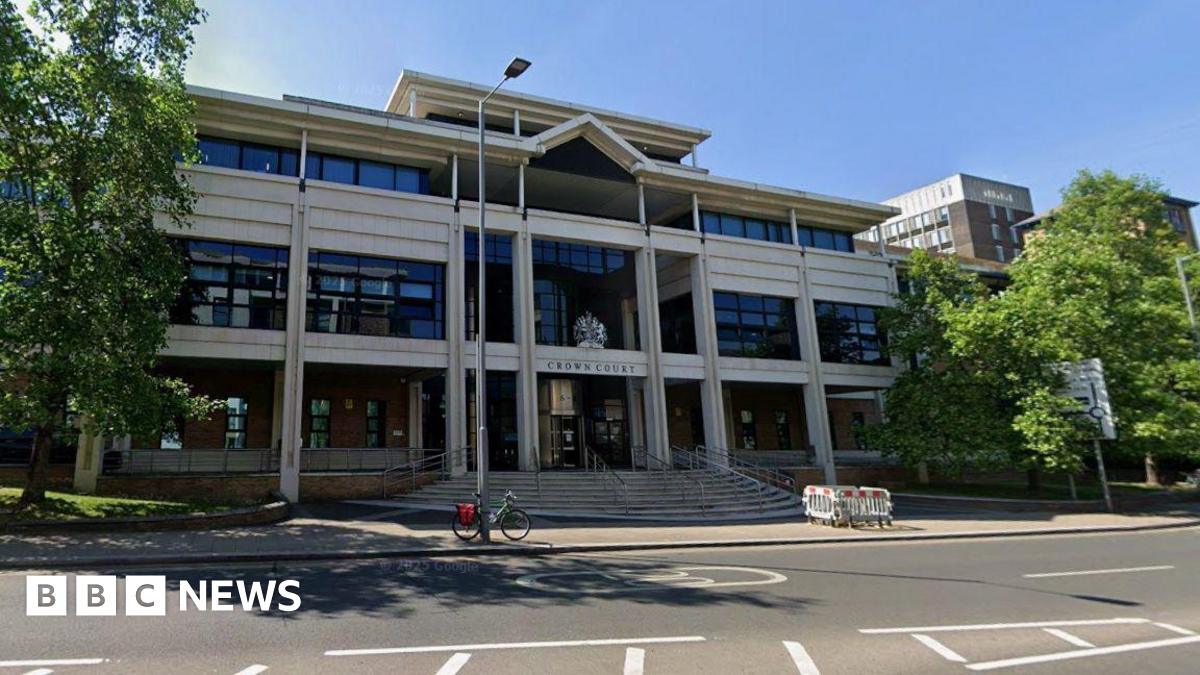 A street view of a court building. There are trees outside the building.