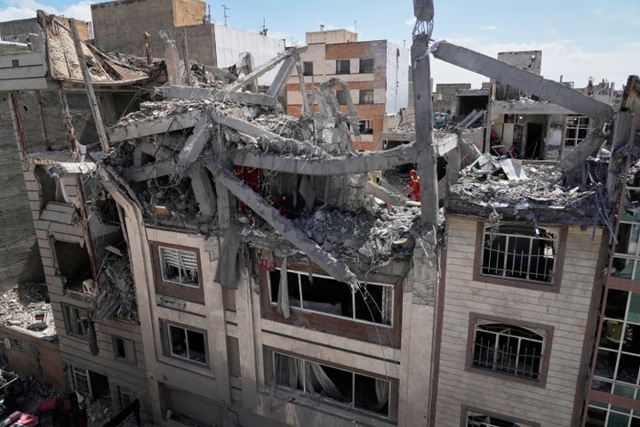First responders inspect a residential building hit in an earlier U.S.-Israeli strike in Tehran, Friday, March 27, 2026. The U.S. military's Central Command has said its operation, known officially as "Epic Fury", is on schedule or even ahead of plans laid out prior to the February 28 start of the U.S. and Israeli attacks on Iran.