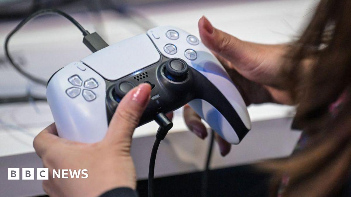 A woman's hands gripping a PlayStation 5 controller.