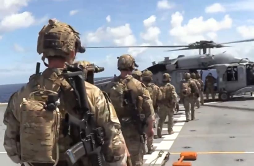 US troops are seen before boarding an oil tanker breaching Washington's blockade on sanctioned vessels traveling to or from Venezuela, February 15, 2026.