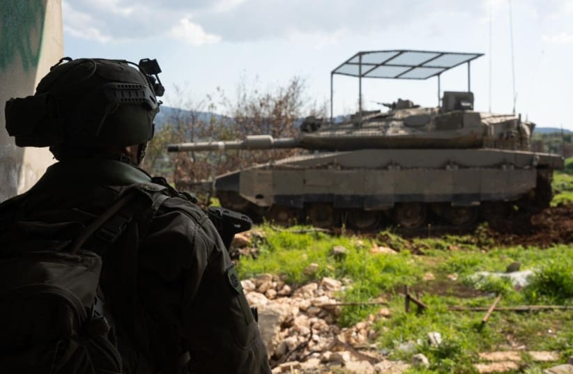 An IDF soldier and a tank are seen operating on the border with Lebanon, in an image released on March 4, 2026. 