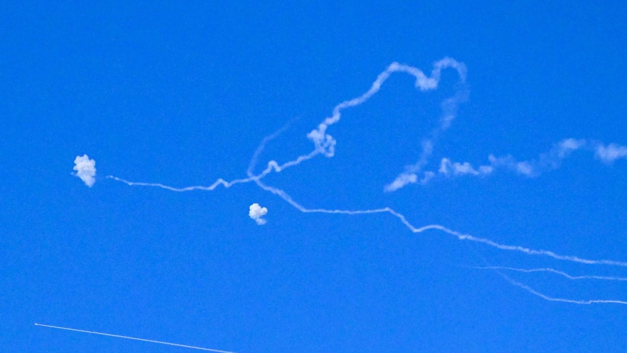 Emergency services respond following a rocket hit in central Israel on Monday, after rockets were launched by Hezbollah in Lebanon.