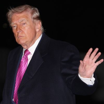 President Trump half waves.