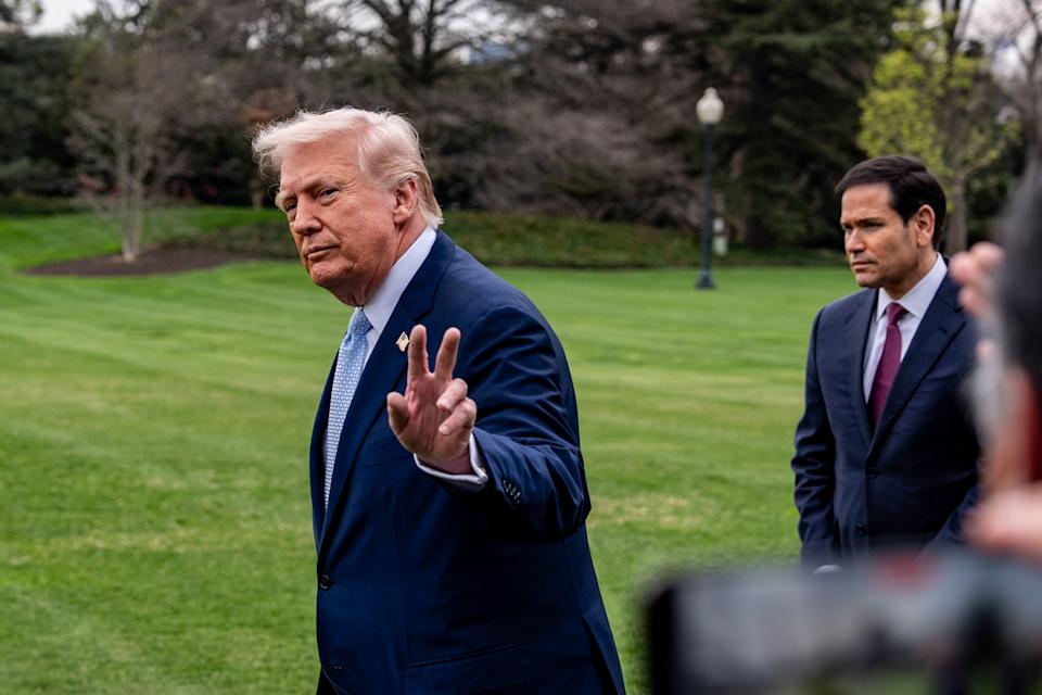 President Donald Trump waves, with Secretary of State Marco Rubio, before departing on Marine One from the South Lawn of the White House, Friday, March 20, 2026, in Washington. (AP Photo/Alex Brandon)