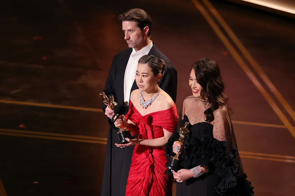 HOLLYWOOD, CALIFORNIA - MARCH 15: (L-R) Chris Appelhans, Maggie Kang, and Michelle Wong accept the Animated Feature Film for