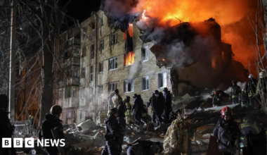 Rescuers work at the site of the apartment building hit by a Russian missile strike in Kharkiv