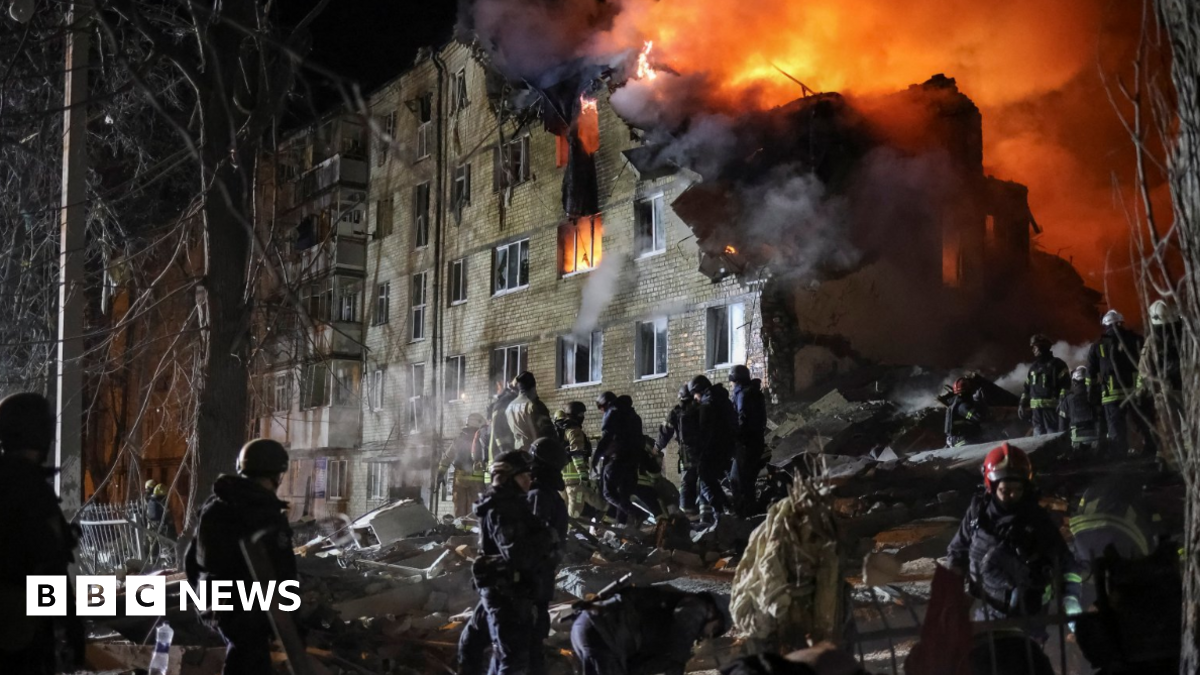 Rescuers work at the site of the apartment building hit by a Russian missile strike in Kharkiv