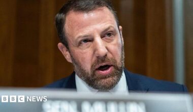 US Senator Markwayne Mullin speaks in the Senate while seated behind a placard that says Sen Mullin.