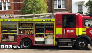 Old Kent Road fire station red doors next to sandy coloured block of flats
