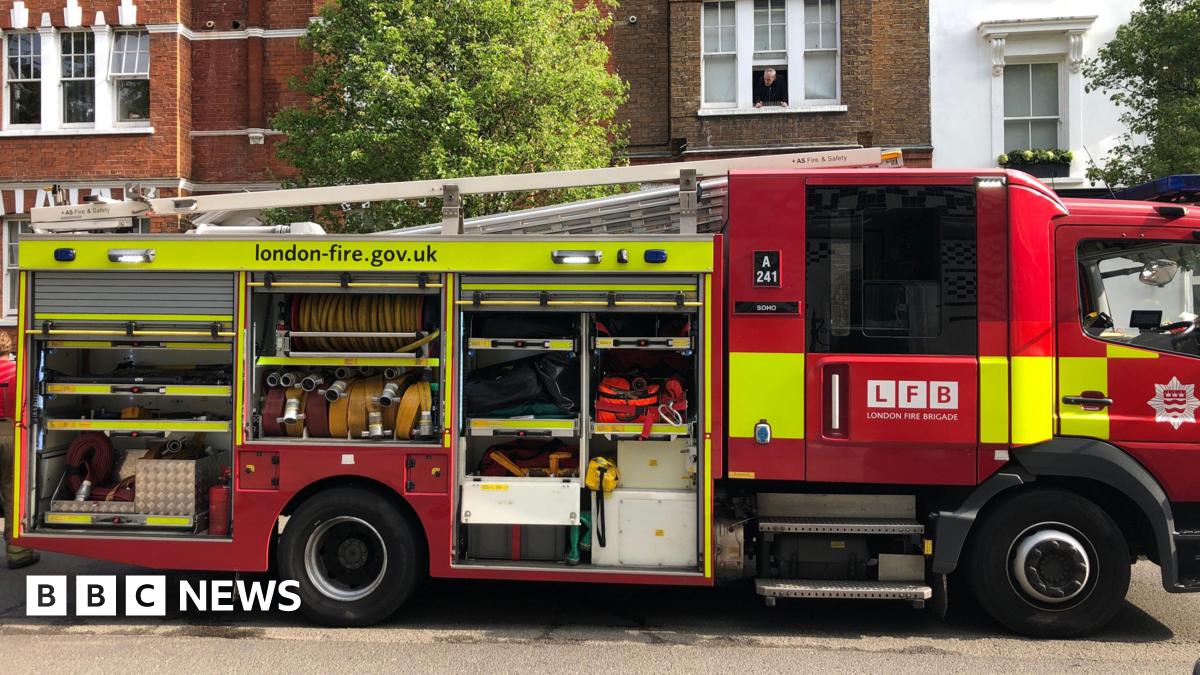 Old Kent Road fire station red doors next to sandy coloured block of flats