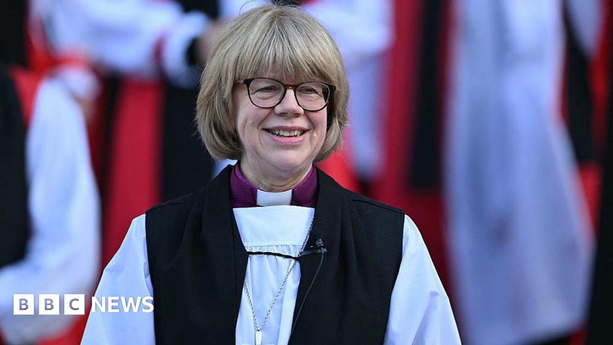 The new Archbishop of Canterbury Sarah Mullally smiles on the steps of St Paul's Cathedral after taking part in a Confirmation of Election ceremony in London on January 28, 2026. She is wearing church gowns.