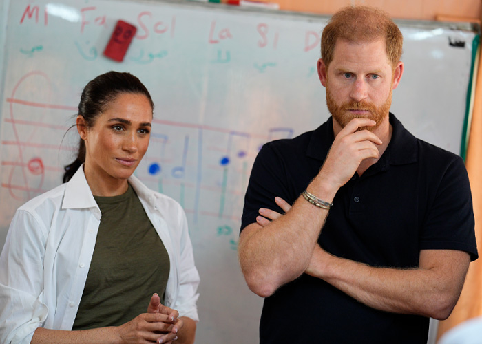 Harry and Meghan in a serious discussion, reacting to bombshell claims with a focused and thoughtful demeanor.