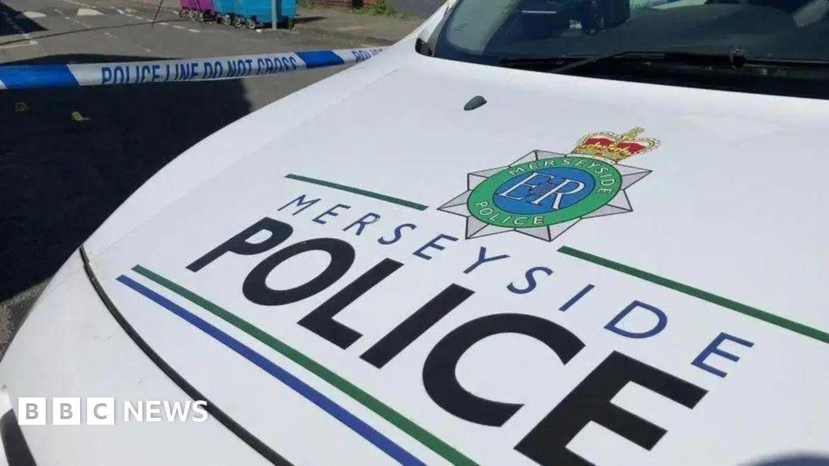 The bonnet of a Merseyside Police car bearing Merseyside Police's logo against a white background