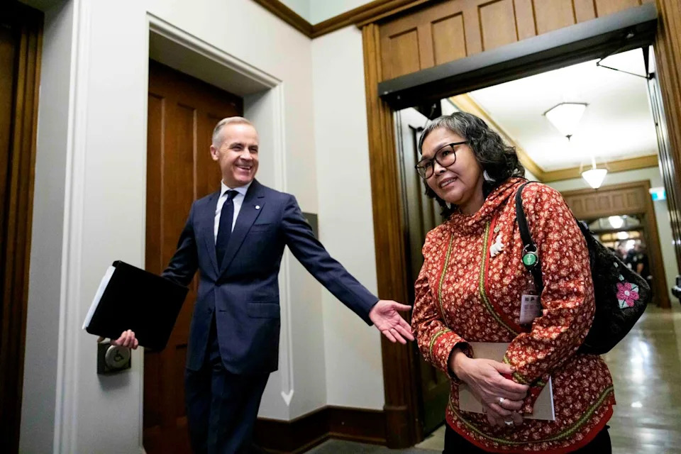 Prime Minister Mark Carney arrives with Nunavut MP Lori Idlout, who crossed the floor from the NDP to the Liberals, as they make their way to a meeting of the Liberal caucus on Parliament Hill in Ottawa March 11.